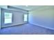 Bright bedroom with carpet and two windows offering natural light at 2123 Cartgate Lane, Winter Haven, FL 33884