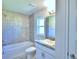Clean bathroom with shower/tub combo, vanity, and tile floor at 2123 Cartgate Lane, Winter Haven, FL 33884