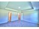 Large bedroom with plush carpeting and access to another room at 2123 Cartgate Lane, Winter Haven, FL 33884