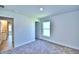 Bright bedroom with carpet flooring, window, and bathroom access at 2123 Cartgate Lane, Winter Haven, FL 33884