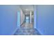 Long hallway with tile floors and access to other rooms at 2123 Cartgate Lane, Winter Haven, FL 33884