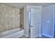 Bathroom with tub and shower combination and tile surround at 2123 Cartgate Lane, Winter Haven, FL 33884