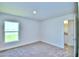 Bedroom with carpet flooring, large window and en-suite bathroom at 2123 Cartgate Lane, Winter Haven, FL 33884
