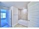 Bathroom with bathtub, tile surround, and open to bedroom at 2123 Cartgate Lane, Winter Haven, FL 33884