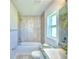 Bathroom with tub, single vanity, and tile shower surround at 2123 Cartgate Lane, Winter Haven, FL 33884