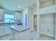 Modern kitchen with white cabinets, granite counters, and stainless steel appliances at 2123 Cartgate Lane, Winter Haven, FL 33884