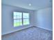 Charming bedroom with a large window and neutral wall at 2123 Cartgate Lane, Winter Haven, FL 33884
