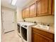 Laundry room with washer, dryer, and cabinets at 1876 Eloise Cove Dr, Winter Haven, FL 33884