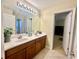 Double vanity bathroom with a large mirror and tile flooring at 1876 Eloise Cove Dr, Winter Haven, FL 33884