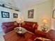 Cozy living room with comfortable sofas and a warm color palette at 1876 Eloise Cove Dr, Winter Haven, FL 33884