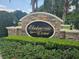 Elegant Eloise Cove entrance with stonework and landscaping at 1876 Eloise Cove Dr, Winter Haven, FL 33884