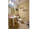 Powder room with pedestal sink and toilet at 1876 Eloise Cove Dr, Winter Haven, FL 33884