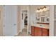 Primary bathroom with double vanity, large mirror, and walk-in closet at 318 Crescent Ridge Rd, Auburndale, FL 33823
