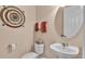 Small half bathroom with a toilet, sink, and oval mirror at 318 Crescent Ridge Rd, Auburndale, FL 33823