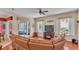 Spacious living room featuring a large sectional sofa and a fireplace at 318 Crescent Ridge Rd, Auburndale, FL 33823