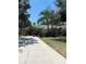 Single-Gathering home with driveway, landscaping, and palm trees at 102 Jardin Ln, Winter Haven, FL 33884