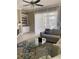 Living room with tile floors, sectional sofa, and access to patio at 102 Jardin Ln, Winter Haven, FL 33884