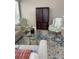 Living area with comfortable seating, a coffee table and large windows at 102 Jardin Ln, Winter Haven, FL 33884