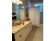 Double vanity bathroom with updated cabinetry and a shower/tub combo at 102 Jardin Ln, Winter Haven, FL 33884