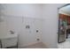 Bright laundry room with utility sink and shelving at 4568 Back Nine Dr, Winter Haven, FL 33884