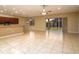 Bright living room with tile floors, ceiling fan, and sliding glass doors to backyard at 4568 Back Nine Dr, Winter Haven, FL 33884