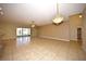 Large living room with tile floors, chandelier, and sliding glass doors at 4568 Back Nine Dr, Winter Haven, FL 33884