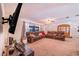 Spacious living room with brown sectional sofa and a large TV at 8881 Cypresswood Dr, Lake Wales, FL 33898