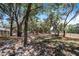 Expansive backyard with mature trees and grassy area at 8881 Cypresswood Dr, Lake Wales, FL 33898
