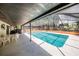 Relax by the pool under the covered patio at 8881 Cypresswood Dr, Lake Wales, FL 33898