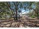 Spacious backyard with fenced pool and large oak trees at 8881 Cypresswood Dr, Lake Wales, FL 33898