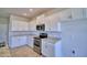 Modern kitchen with white cabinets, granite countertops and stainless steel appliances at 1472 Leamington Ln, Winter Haven, FL 33884