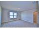 Bedroom with a window, carpet, and walk-in closet at 1472 Leamington Ln, Winter Haven, FL 33884