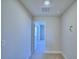 Simple hallway with carpeted floor leading to bedroom at 1472 Leamington Ln, Winter Haven, FL 33884