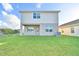 Two-story house with light beige siding and a covered patio at 1472 Leamington Ln, Winter Haven, FL 33884