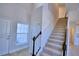 Two story entryway with tile flooring, staircase, and coat closet at 1472 Leamington Ln, Winter Haven, FL 33884