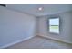 Well-lit bedroom featuring a window and carpet at 1472 Leamington Ln, Winter Haven, FL 33884