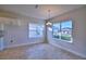 Bright dining area with large windows and a stylish chandelier at 1472 Leamington Ln, Winter Haven, FL 33884