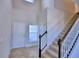 Two story entryway with tile flooring, staircase, and coat closet at 1472 Leamington Ln, Winter Haven, FL 33884