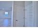 Bright hallway with two closed doors and tile flooring at 1472 Leamington Ln, Winter Haven, FL 33884