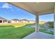 Covered patio overlooking a grassy backyard and neighboring homes at 1472 Leamington Ln, Winter Haven, FL 33884