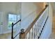 Elegant staircase with wood railing and white spindles at 1472 Leamington Ln, Winter Haven, FL 33884