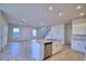 Open kitchen with island, white cabinets, and stainless steel appliances at 1472 Leamington Ln, Winter Haven, FL 33884