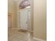 Light-toned entryway with tile floor and white door at 4568 Back Nine Dr, Winter Haven, FL 33884