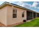 Exterior view of home with screened lanai and well-manicured lawn at 4568 Back Nine Dr, Winter Haven, FL 33884