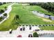 Aerial view of driving range with golf carts and practice stations at 4568 Back Nine Dr, Winter Haven, FL 33884