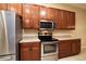 Modern kitchen with stainless steel appliances and wood cabinets at 4568 Back Nine Dr, Winter Haven, FL 33884