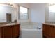 Double vanity bathroom with corner tub and window at 4568 Back Nine Dr, Winter Haven, FL 33884