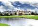 Lake Ashton community clubhouse with a pond in front at 4568 Back Nine Dr, Winter Haven, FL 33884