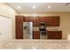 Kitchen with wooden cabinets and stainless steel appliances at 4568 Back Nine Dr, Winter Haven, FL 33884