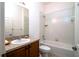 Neat bathroom with shower/tub combo and wood cabinets at 4568 Back Nine Dr, Winter Haven, FL 33884